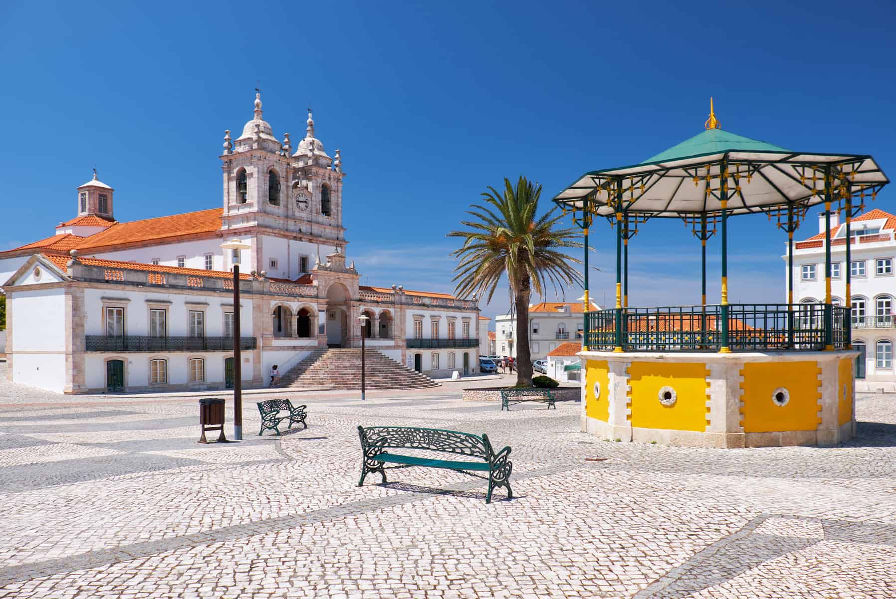 The central square of Nazare with pavilion and Nossa Senhora da Nazare Church on the background. Portugal