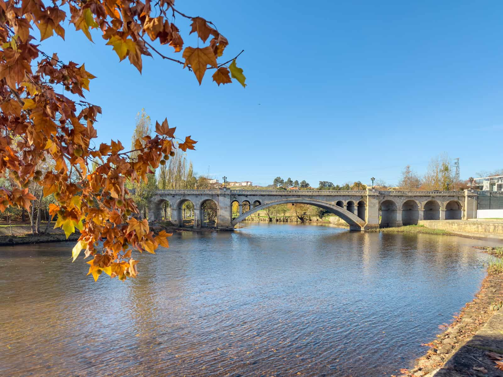 View along the Tâmega River city park in Chaves, Portugal.