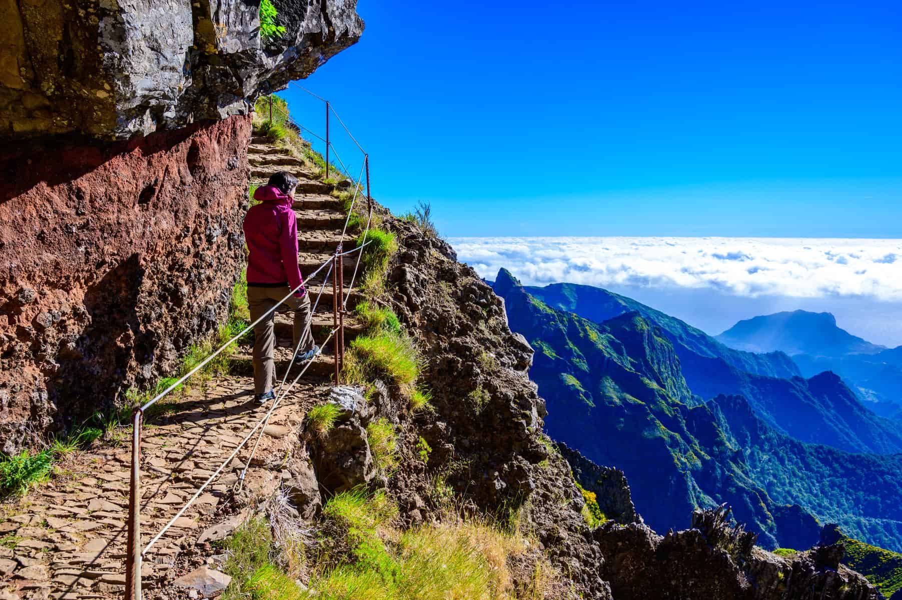 Beautiful hiking trail from Pico do Arieiro to Pico Ruivo, Madeira island. Footpath PR1 - Vereda do Areeiro. On summy summer day above the clouds. Portugal.